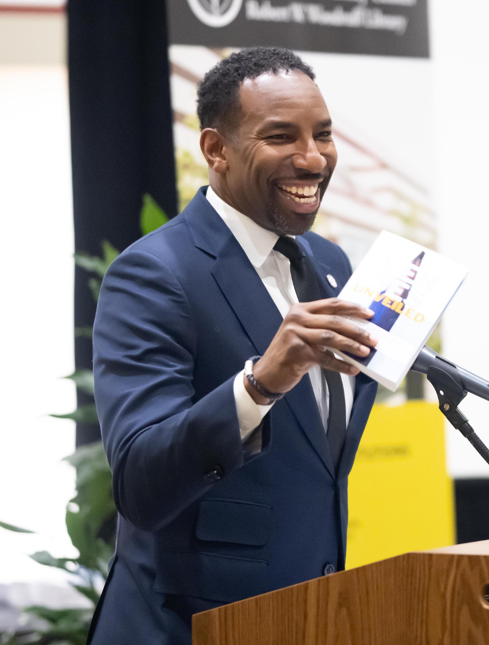 Mayor Andre Dickens holding a Beyond Literacy student book